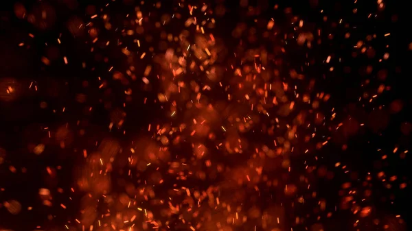 Gece gökyüzündeki büyük ateşten yanan kırmızı kıvılcımlar uçuşuyor. Ateş, ışık ve yaşam teması üzerine çok soyut bir arka plan. Yanan közler siyah arkaplan üzerinde uçan parçacıklar.