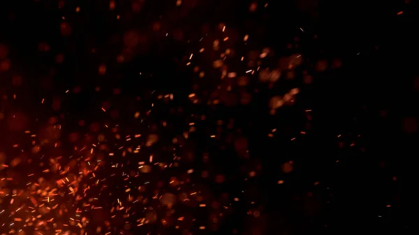 Gece gökyüzündeki büyük ateşten yanan kırmızı kıvılcımlar uçuşuyor. Ateş, ışık ve yaşam teması üzerine çok soyut bir arka plan. Yanan közler siyah arkaplan üzerinde uçan parçacıklar.