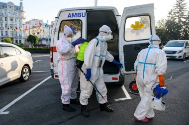 Koruyucu giysiler içindeki sağlık çalışanları, COVID-19 salgını nedeniyle Vinnytsia 'daki dezenfekte binasına geldiler.