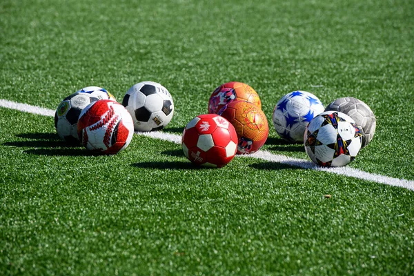 Variety Soccer Balls Lie Green Lawn Football Field Front Goal — Stock Photo, Image