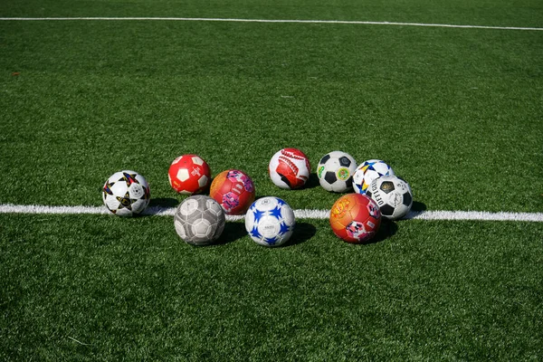 Variety Soccer Balls Lie Green Lawn Football Field Front Goal — Stock Photo, Image