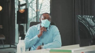 Yüzü gülümseyen Afrikalı Amerikalı genç adam. Maskeyi çıkar. Modern ofis çalışanlarının başarılı portresini çek.