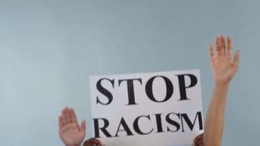 Arka planda tecrit edilmiş çeşitli ırklar arası insanların elleri. Siyah Erkek Eller Irkçılığı Durdurun Afişi Gösteriyor. Siyahların Yaşamı Önemlidir. Anti-tiryakilik. Eşitlik.