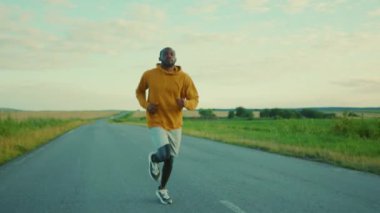 Yakışıklı Afro-Amerikan sporcusu. Güneşli yol maratonunda koşuyor. Sağlıklı spor.