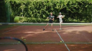 Yavaş hareket eden kadın ve erkek tenis oynuyor. Atletik güçlü atletik oyun antrenmanı. Boş zamanlardaki spor tenis topunu yakın çekim.