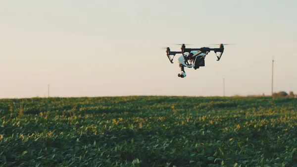 Flying smart agriculture drone in sky rural aerial helicopter agros copter farm farming field industry landscape meadow nature plant professional vehicle aircraft harvest innovation slow motion