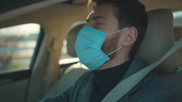Sick man gets in the car coughs sneeze wearing Protective Face Mask COVID-19 coronavirus infection pandemic disease virus male tourist epidemic air health illness slow motion