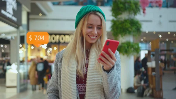 App Icon with Online Transaction. Financial Transactions in the Smartphone. Receive a Message About Increase Money. Smiling Young Woman Uses Phone in The City Center on Happy Internet.