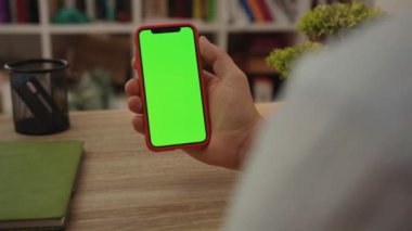 NEW YORK - 19 Mayıs 2019: Genç adam cep telefonunu dikey yeşil ekran masa başı işi ile kullanıyor gündelik boş teknoloji dijital mobil akıllı telefon internet dokunmatik ekranını yavaşça kapatın