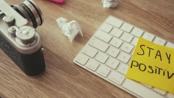 Close-up wooden working table desktop with artists mess and crumpled paper balls. Creative disorder, lack of ideas. Stay positive no matter what. Business, motivation. Royalty Free Stock Footage