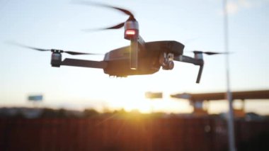 Güzel günbatımı makinesinde uçan kuadkopter modern iş tasarımı çerçeve silueti insan teknolojisi güneş hava kontrol hava polis kameraları uzaktan kumandalı robot hobileri uçak hobileri