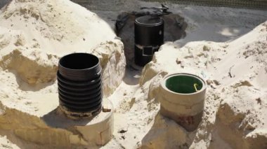 Siyah plastik boruları kapatın. Kirlilik teknolojisi. Çöplük çevresi. Endüstriyel beton.