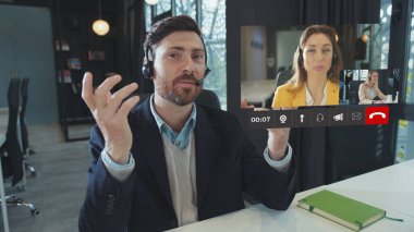 Skype Gelen Arama Animasyonu. Video konferansı. Beyaz tenli yakışıklı iş adamı iş arkadaşlarıyla Online İş Toplantısı 'nda Genç Kadınlar Takımına liderlik ve konuşma yapıyor. İşbirliği. Sosyal Mesafe
