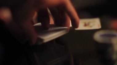 Poker kartlarını karıştıran, joker kartını seçen erkek satıcıya odaklan. Hileli oyun, beyefendiler kulübü, erkek stili, risk almak, her şeyiyle oynamak. Kazanan, kaybeden. Görüntüyü kapat