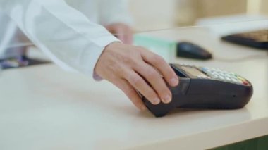 Eczanedeki cep telefonu ödemesini kullanarak kadın eli kapat. Eczacılık sağlık hizmetleri telefon mağazası alım satımı. Yavaş çekim