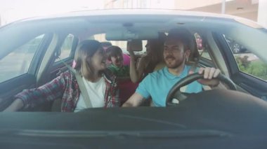 NEW YORK - 5 Nisan 2018: Çocuklu güzel bir aile arabayla deniz kenarına gidiyor. Sevgi dolu bir külüstür ve kardeşlerinin arabada oturup gülümsemesi..