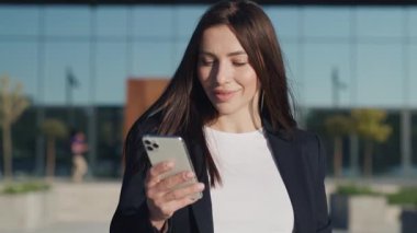 Şehir merkezinde gün ışığında telefonla dolaşan güzel ve çekici bir kadın etrafına bir bak. Cep telefonu olan bir portre kızı. Yavaş çekim