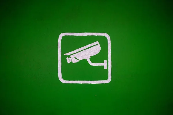 Yeşil bir arka plan üzerinde video gözetim hakkında çizilmiş işareti