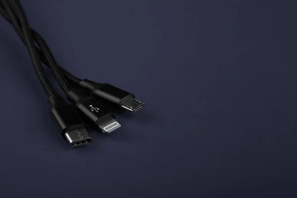 Closeup Shot of Universal USB Cable. 3 different cellphone usb charging plugs adapter from USB
