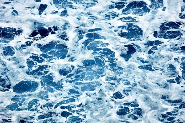 Rough sea close up. Beautiful blue waves with a lot of sea foam