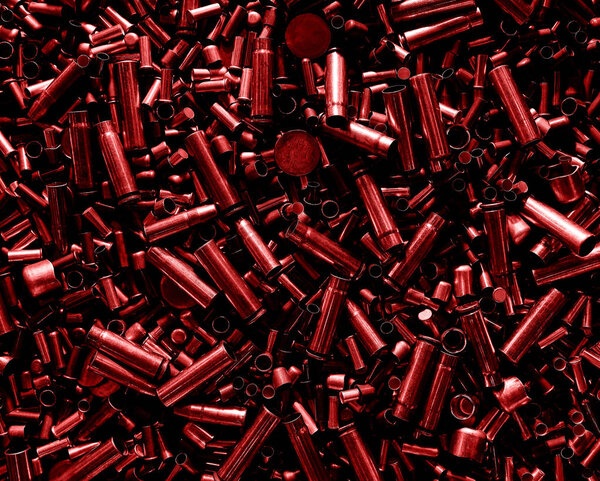 Different size bullet shells on the black ground. War concept.