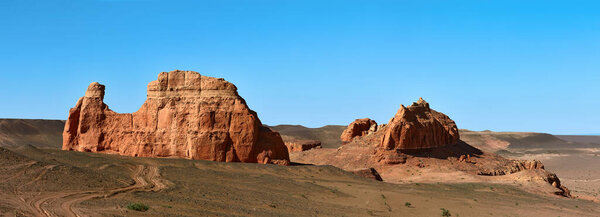 Herman Cav Canyon at sunset. South Gobi, Mongolia. Herman Tsav Canyon. Red Sandstone plateau, Martian landscape. The site of many paleontological finds. Cemetery of dinosaurs.