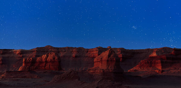 Herman Cav Canyon at night. South Gobi, Mongolia. Herman Tsav Canyon. Red Sandstone plateau, Martian landscape. The site of many paleontological finds. Cemetery of dinosaurs.