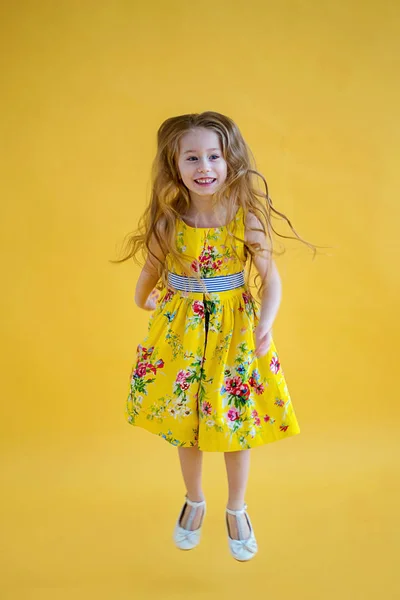 Cheerful Cute Girl Beautiful Dress Jumping Colored Yellow Background — Stock Photo, Image