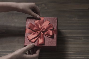 hediye untiechildren'ın elleri hediye kutusu ahşap arka plan, üstten görünüm üzerinde pruvada çöz. gradyan arka planı.