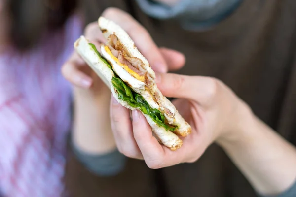 Дівчина тримає свіжий смачний клубний бутерброд . — стокове фото