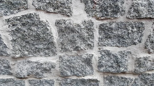 Gray stone wall background. The texture of the stone. Old castle wall background. Stone wall as a background or texture. Part of the wall, for background or texture. — Stock Photo, Image