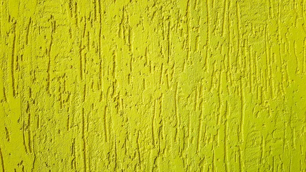 Stare złoto tynki ścienne tekstury żółte tło. Teksturowane tynki ścienne. Tłoczona Dekoracja ścienna. Ściany sztukaterie. Tłoczona Dekoracja ścienna. Tynki dekoracyjne są malowane na żółto. — Zdjęcie stockowe