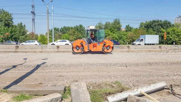 Oekraïne, Kiev - 1 oktober 2019: Wegroller, tractor en bouwmachines werken aan een nieuwe wegbouwplaats. De weg is gesloten voor wegreparatie, routeverlenging, kuil reparatie — Stockfoto