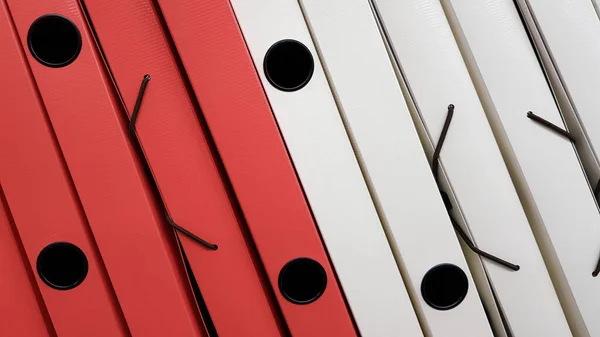 Various office folders on a supermarket shelf. Plastic and paper folders with documents are on the shelf of the cabinet. — Stock Photo, Image