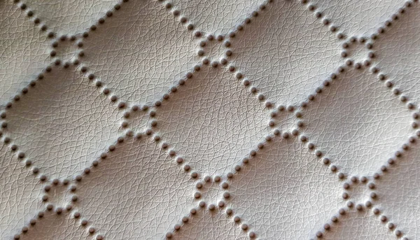 Beige quilted leather headboard seamless pattern, luxury soft leather background. Headboard, bed. Background texture of soft leather furniture, line and buttons