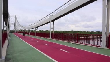 Ukrayna, Kiev - 2 Haziran 2020: Dinyeper Nehri üzerindeki park yaya köprüsü, Kiev 'in merkez bölümünü park alanı ve Trukhaniv Adası plajlarına bağlar.
