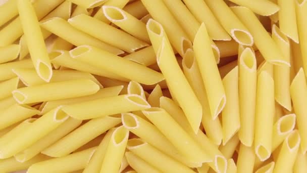 Slowly Spinning Raw Penne Rigate Short Pasta Oblique Cuts Ribbed — Stock Video