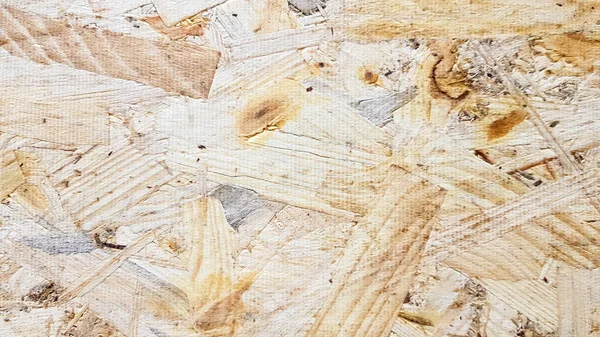 OSB sheet is made of pressed brown wood shavings. Attic wall surfaces. Material for building a house