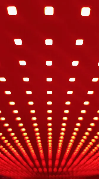 RGB LED screen panel texture. Close-up of a pixel LED screen with bokeh for wallpaper. Bright red abstract background perfect for any design