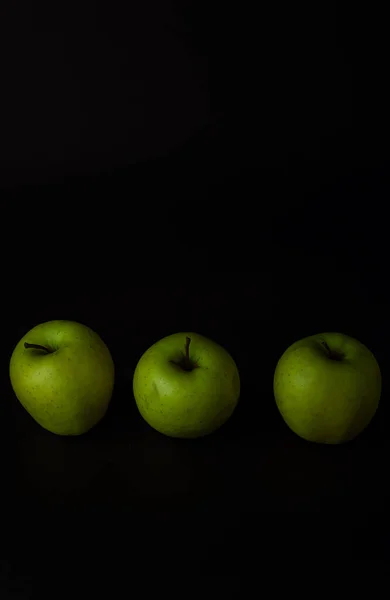green apples on black background