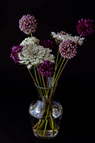 bouquet of natural flowers in clear glass vase