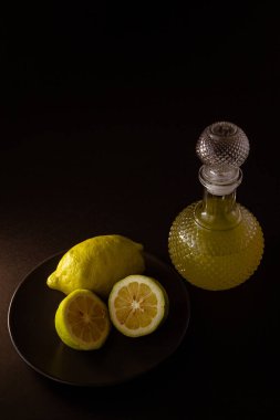 limoncello geleneksel İtalyan limon likörü, şişe, cam ve taze limon dilimleri.