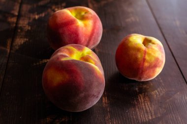 Tahta masa ve mutfak bıçağında taze şeftalilerle dolu bir hayat.