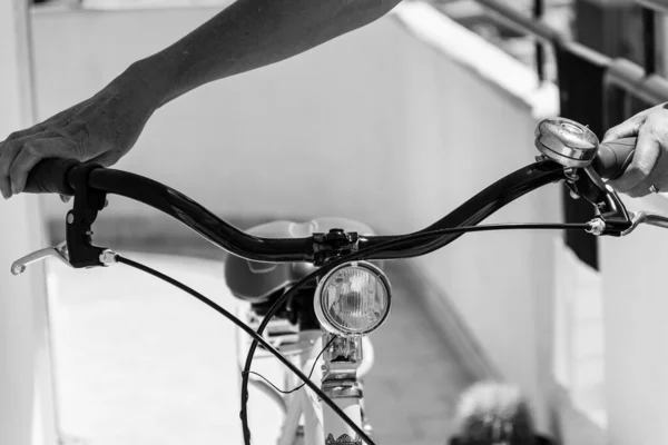 close up of woman holding bicycle in details, black and white photo