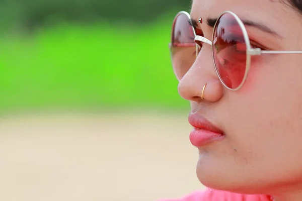 macro profile view woman face closeup gorgeous pink lips in Natural summer fashion wearing sunglasses. concept to care ( skin , eyes ) upper body part etc