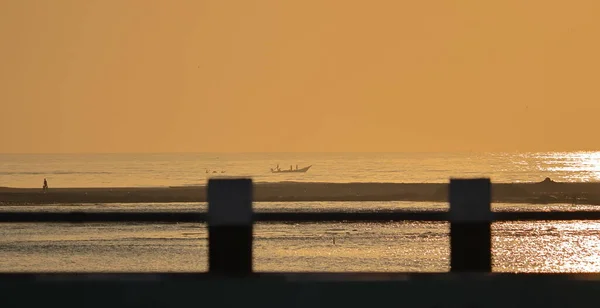 다리에서 햇빛을 황금빛 나뭇가지에 실루엣 보트에 어부들이 물고기를 — 스톡 사진
