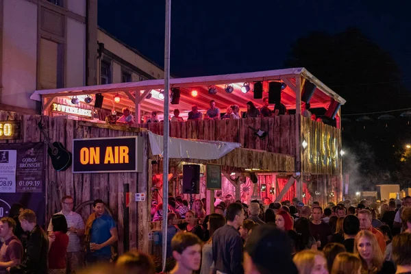 Stadtfest Brugg 24th of august 2019. Red enlightened restaurant called Lasso by night.