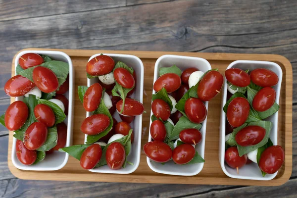 Closeup Red Cherry Tomatoes Fresh Basil Mozzarella Cheese Appetizers Sprinkled — Stock Photo, Image