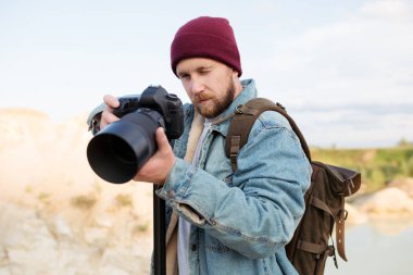 A professional photographer shoots wildlife with his camera