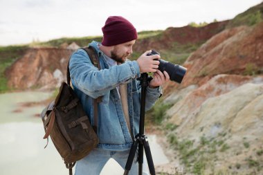 A professional photographer shoots wildlife with his camera